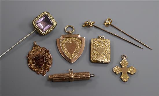 Two 9ct gold watch fobs, a 9ct gold cross pendant, another pendant, a 9ct gold propelling pencil and three stickpins.